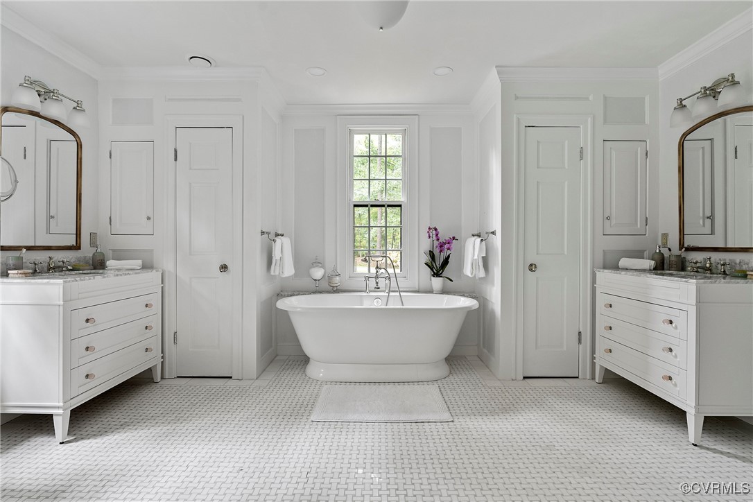 10700 Darby Circle Midlothian, VA 23113 - Photo 32 of 50 a bathroom with a double vanity sink a mirror a bathtub and window
