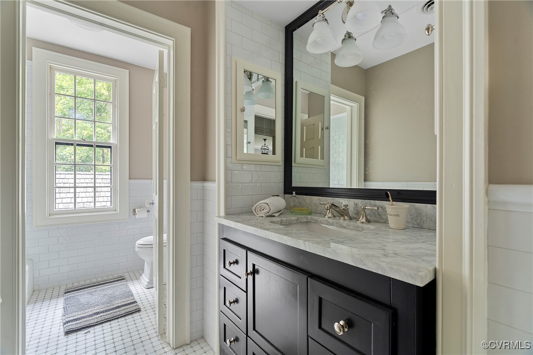 10700 Darby Circle Midlothian, VA 23113 - Photo 39 of 50 a bathroom with a granite countertop sink and a mirror