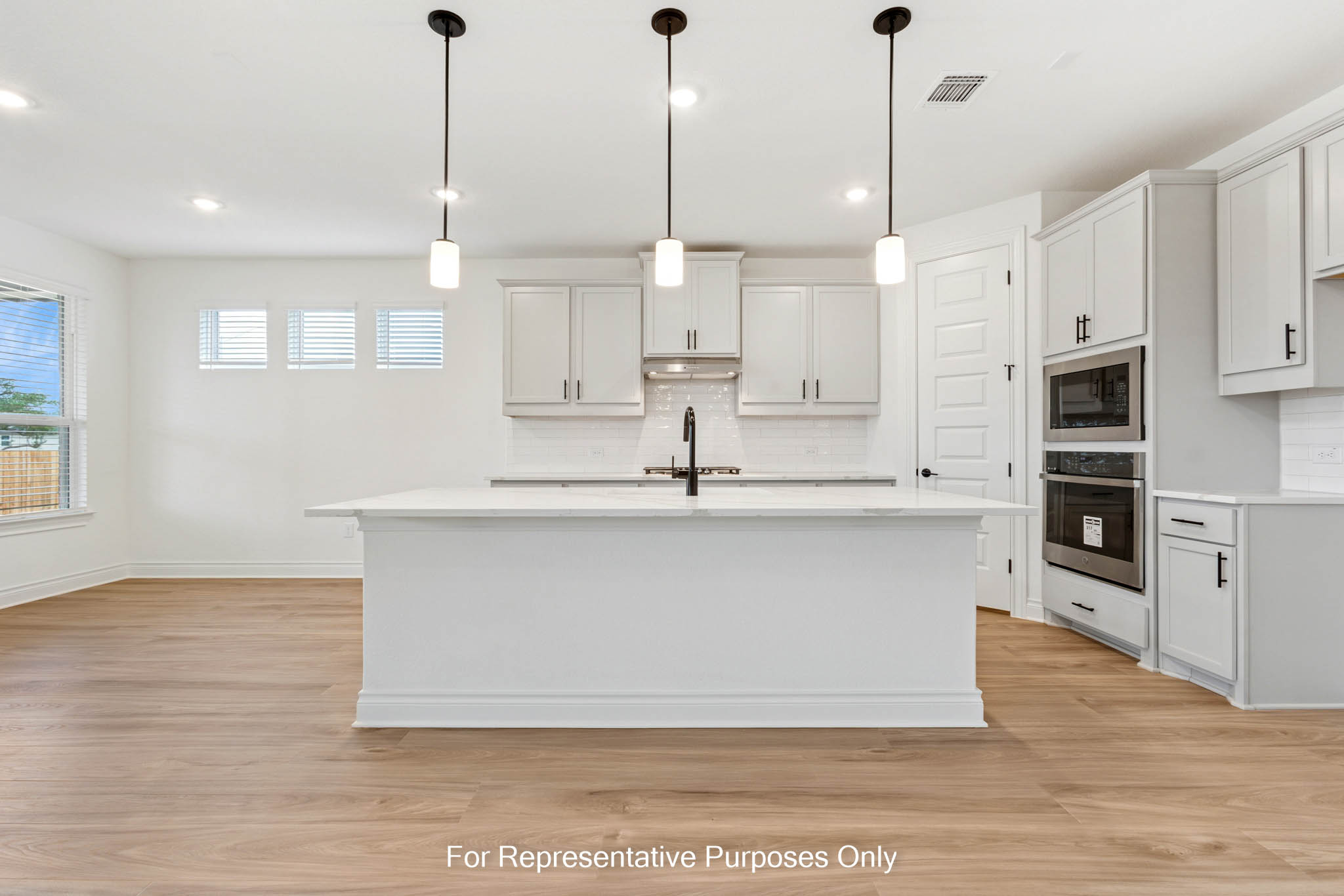 3721 Helena Way Leander, TX 78641 - Photo 7 of 15 a large kitchen with stainless steel appliances a large counter top a stove a refrigerator a sink and a window