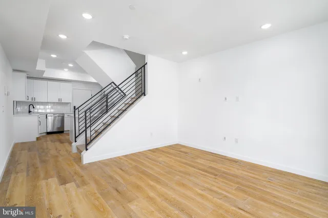 a view of entryway and hall with wooden floor