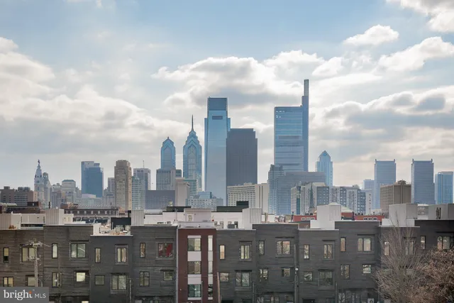 a view of a living room with furniture and wooden floor