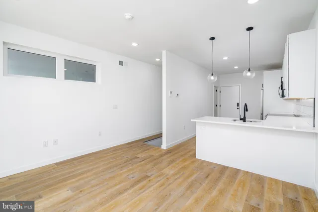 a view of a kitchen with wooden floor