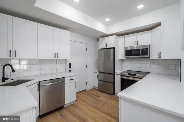 a kitchen with a white stove top oven and refrigerator