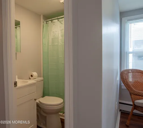 a bathroom with a toilet a sink and a mirror