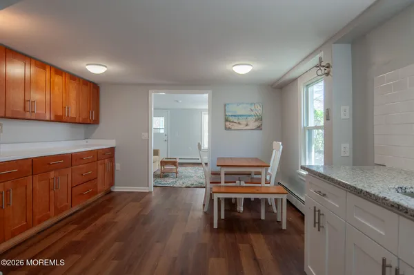 a kitchen with sink cabinets and wooden floor