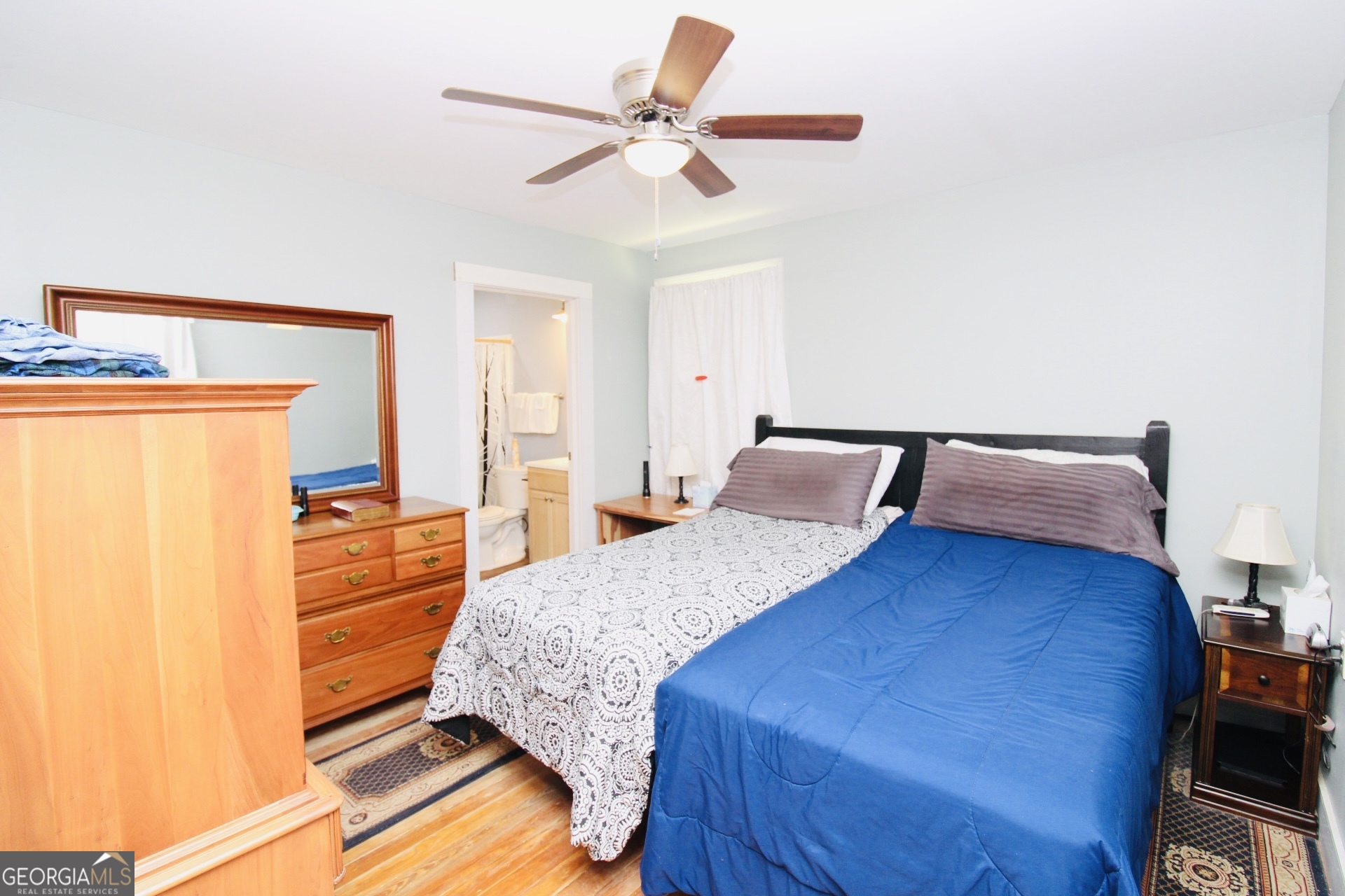218 6th Avenue Rochelle, GA 31079 - Photo 11 of 22 a bedroom with a bed and wooden floor