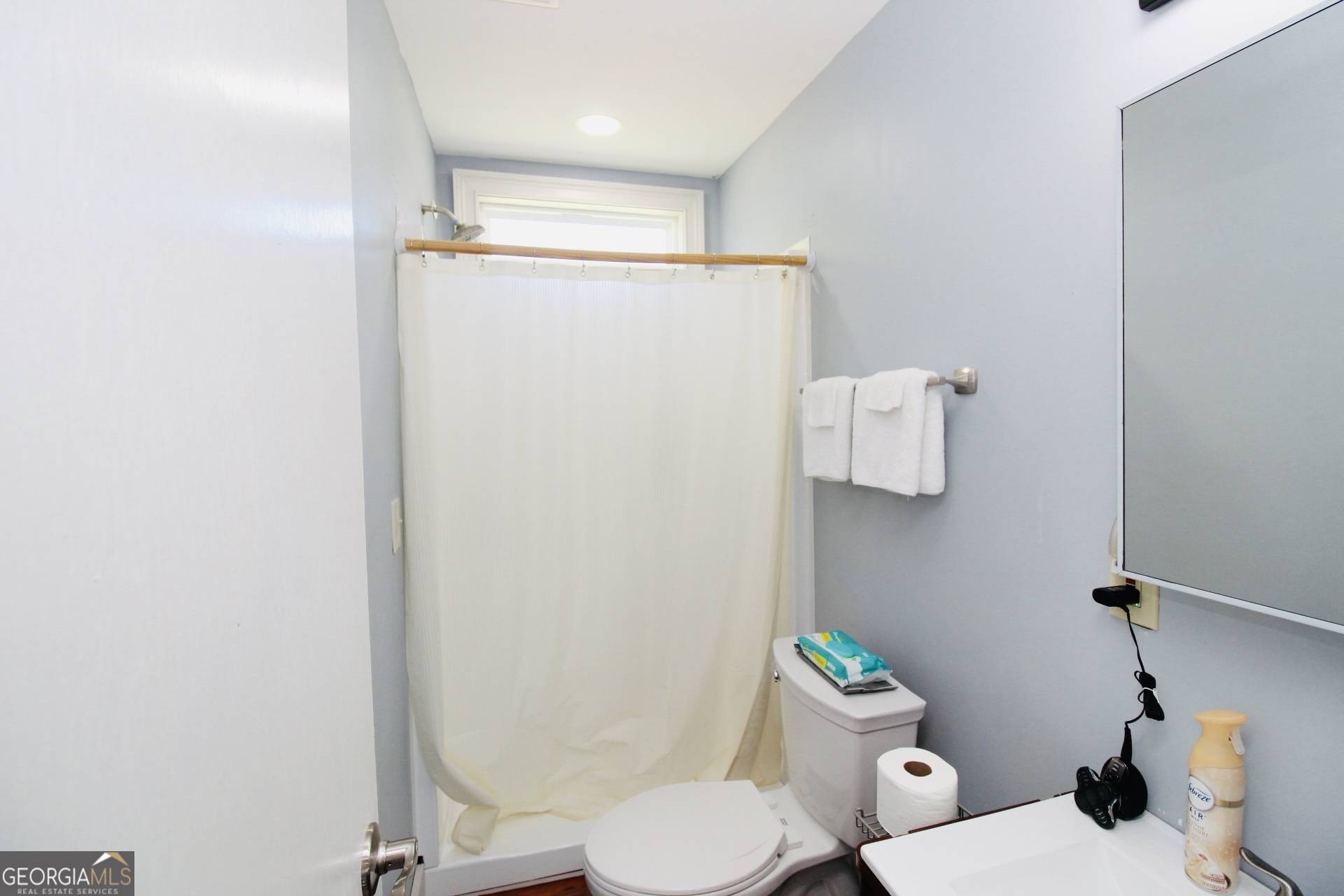 218 6th Avenue Rochelle, GA 31079 - Photo 15 of 22 a white toilet sitting next to a bathroom sink and a shower