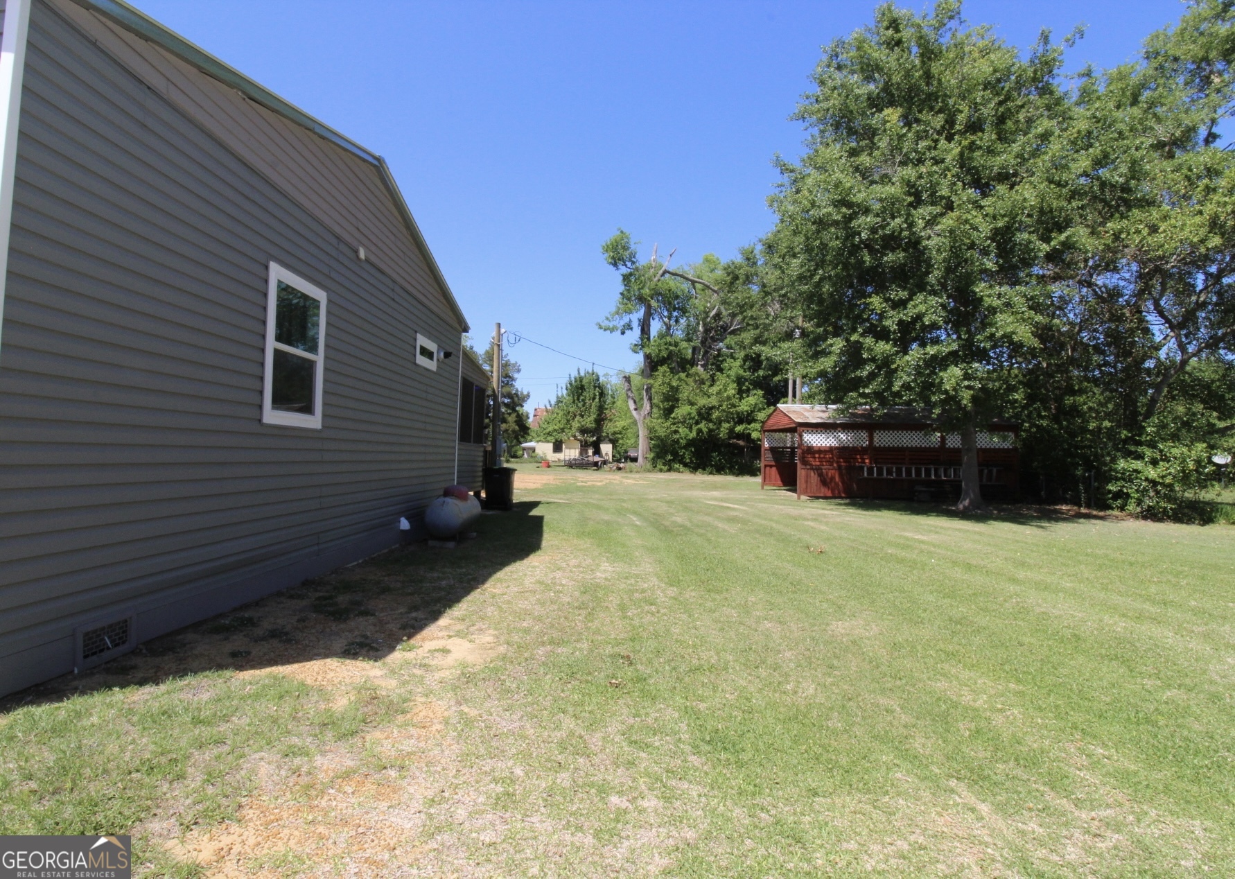 218 6th Avenue Rochelle, GA 31079 - Photo 21 of 22 a backyard of a house with lots of green space