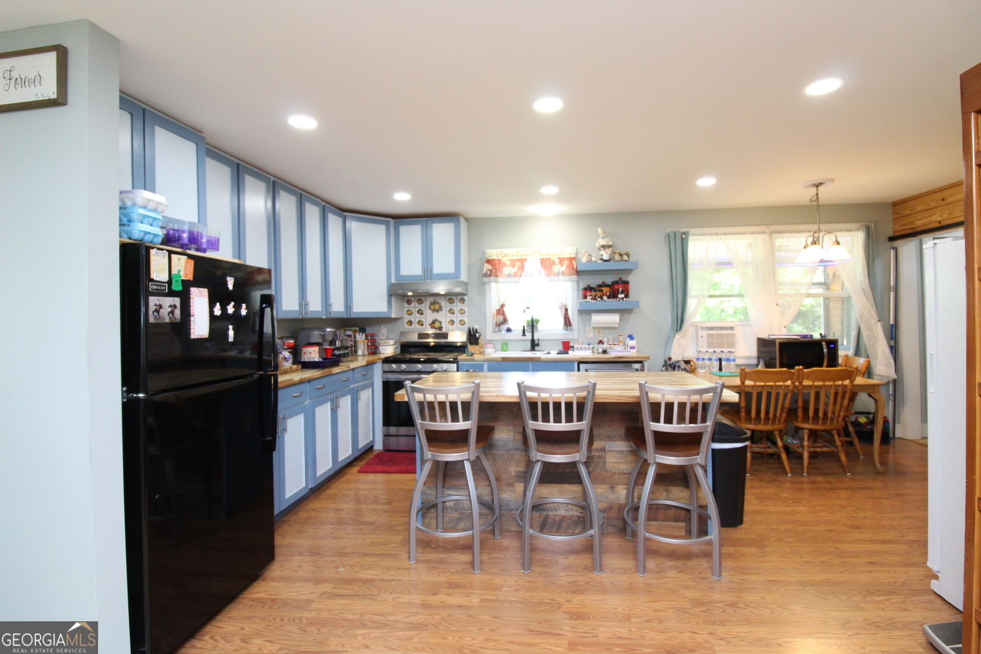 218 6th Avenue Rochelle, GA 31079 - Photo 5 of 22 a kitchen with stainless steel appliances kitchen island granite countertop a dining table chairs and a refrigerator