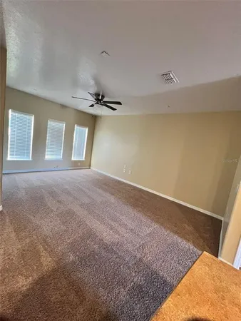 a white toilet sitting next to a white sink and vanity
