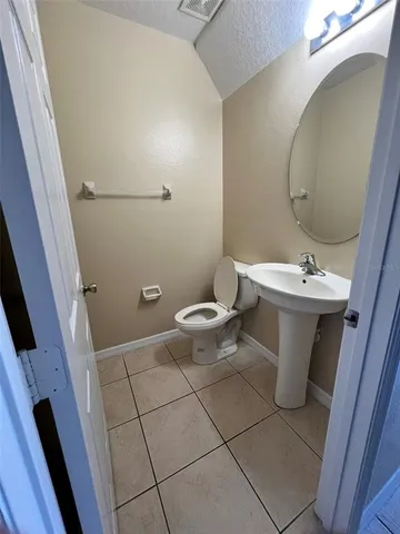 en empty room with windows and chandelier fan