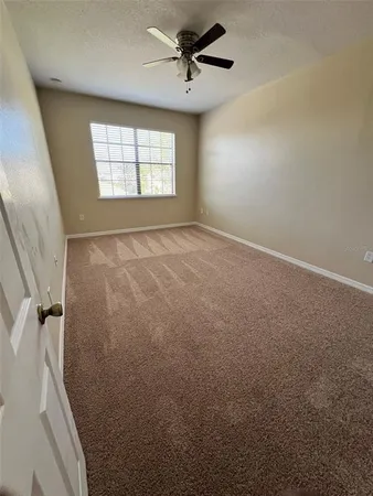 a view of a hallway with wooden floor and stairs