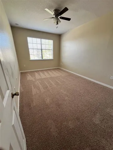 a view of a hallway with wooden floor and stairs