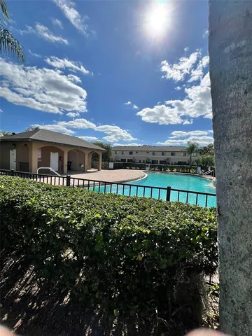 a view of a swimming pool with an outdoor seating and a yard