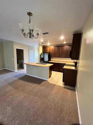 a kitchen with stainless steel appliances a sink stove and microwave