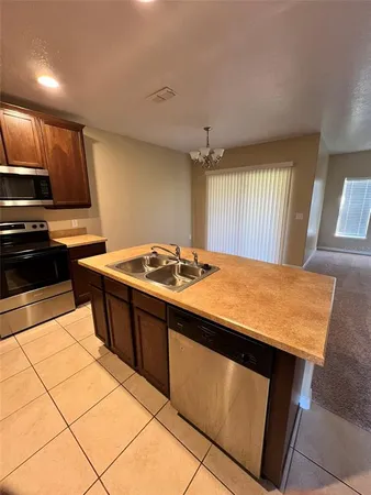 a kitchen with a refrigerator a sink and cabinets