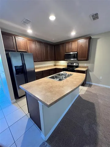 a stove top oven sitting inside of a kitchen