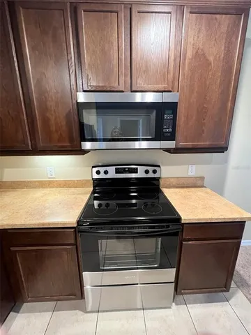 a kitchen with stainless steel appliances granite countertop a refrigerator sink and stove