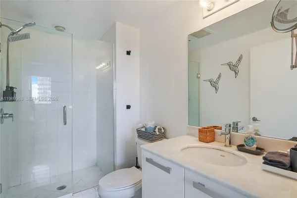 a bathroom with a sink toilet and shower