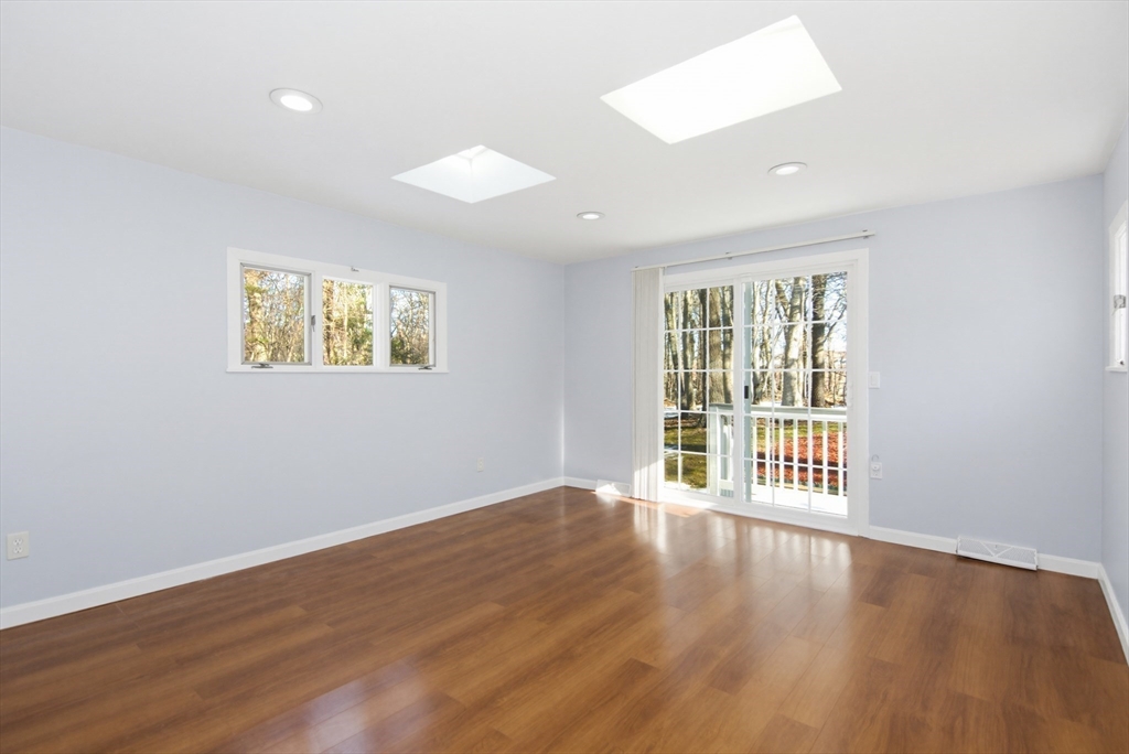31 Spring Lane Sharon, MA 02067 - Photo 14 of 33 an empty room with wooden floor and windows