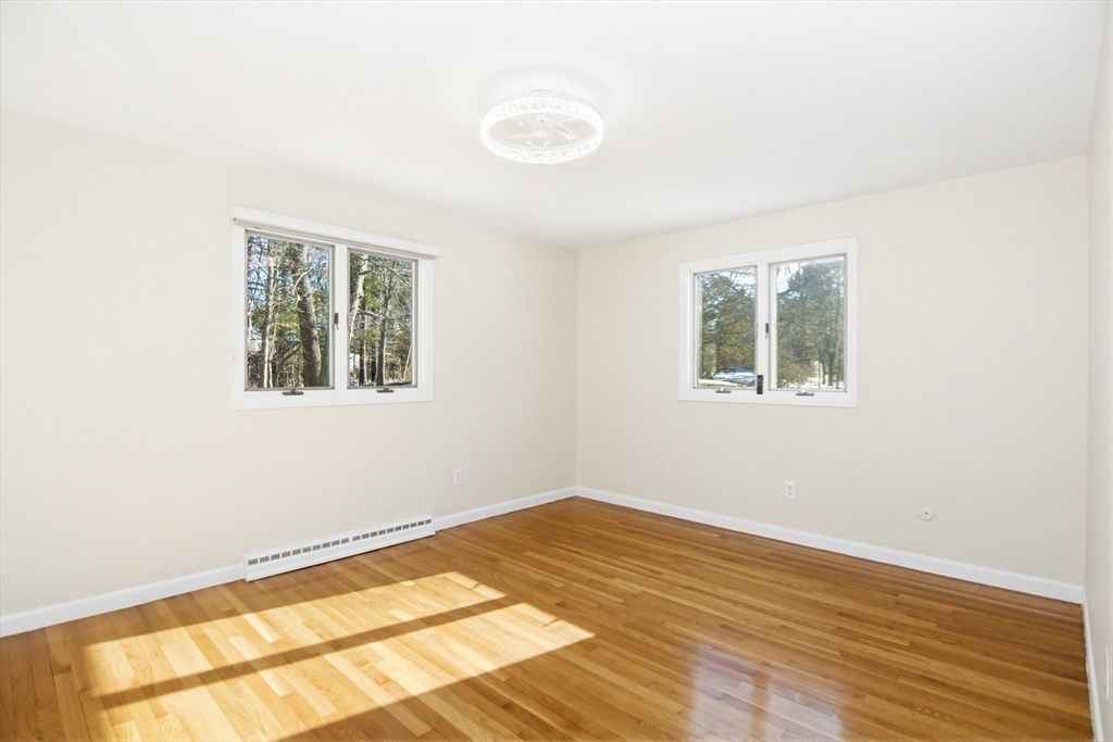 31 Spring Lane Sharon, MA 02067 - Photo 17 of 33 a view of an empty room with wooden floor and a window