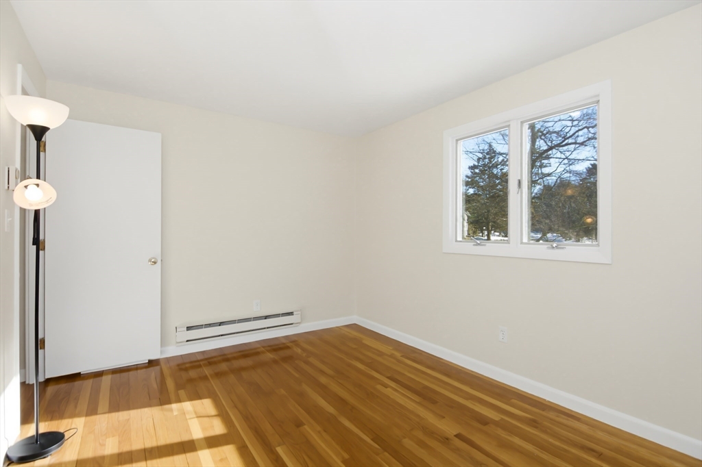 31 Spring Lane Sharon, MA 02067 - Photo 19 of 33 a view of empty room with wooden floor and fan