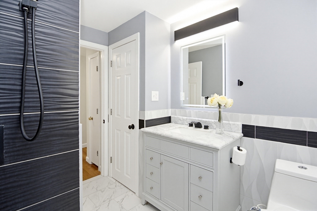 31 Spring Lane Sharon, MA 02067 - Photo 21 of 33 a bathroom with a sink a toilet and shower