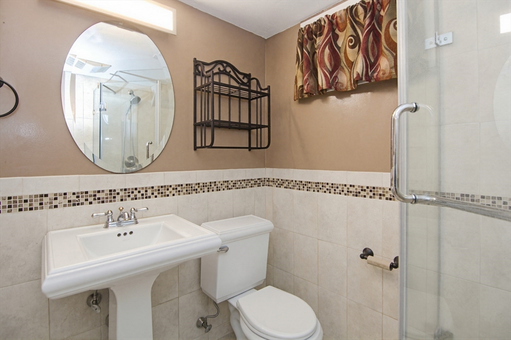 31 Spring Lane Sharon, MA 02067 - Photo 24 of 33 a bathroom with a sink a toilet and a mirror