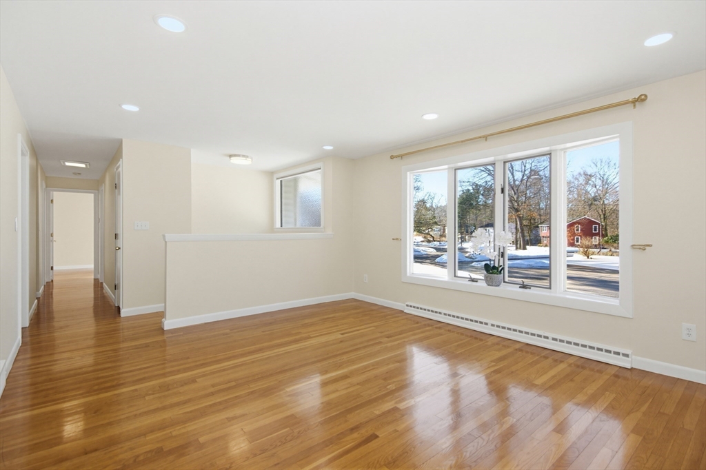 31 Spring Lane Sharon, MA 02067 - Photo 8 of 33 an empty room with wooden floor and a floor to ceiling window