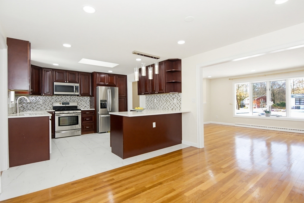 31 Spring Lane Sharon, MA 02067 - Photo 9 of 33 a large kitchen with stainless steel appliances granite countertop a stove a sink and a refrigerator