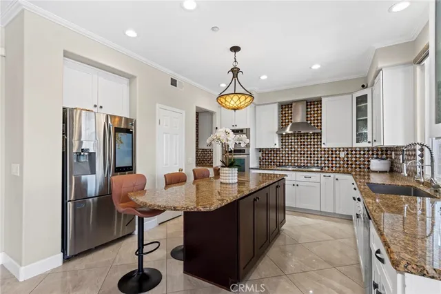 a kitchen with a granite countertop sink and a large mirror next to a window