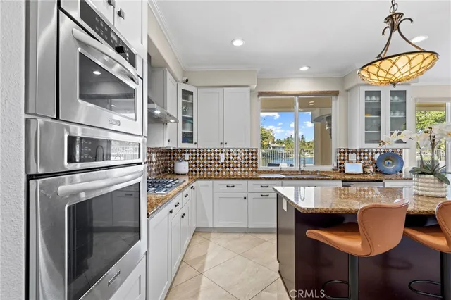 a large kitchen with a large window and kitchen view