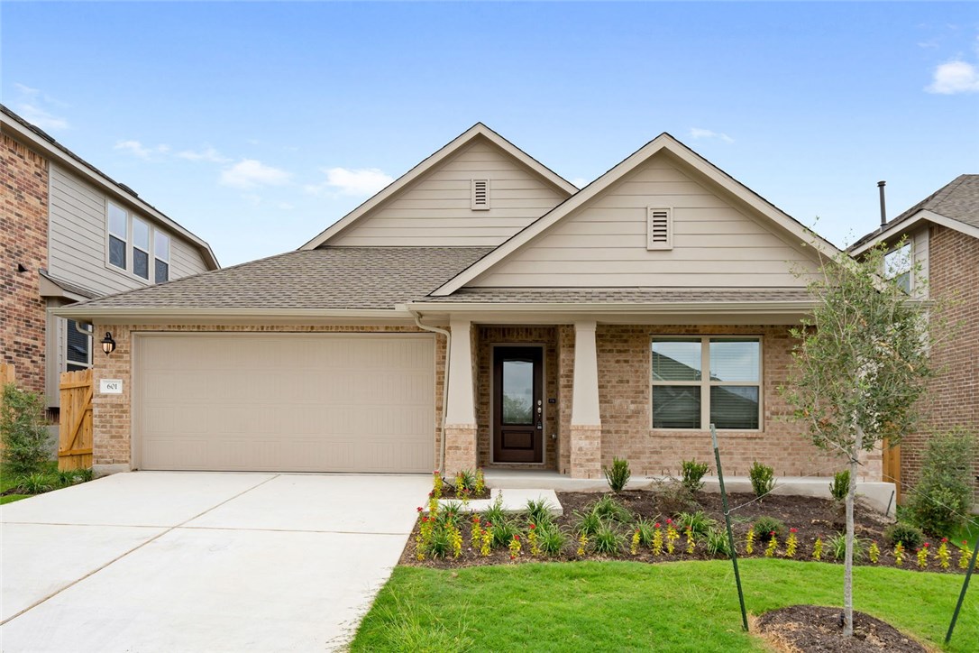 a front view of a house with a yard and porch