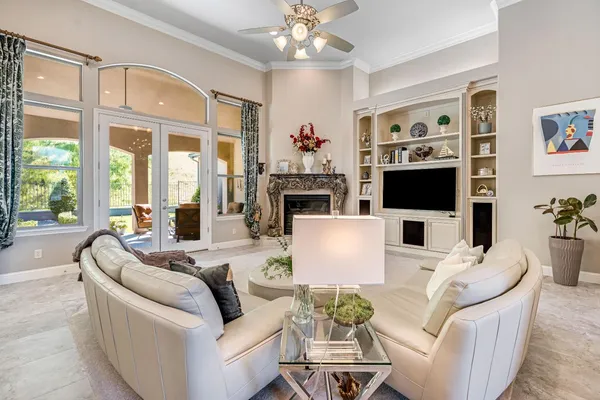 a kitchen with stainless steel appliances granite countertop a stove top oven a sink a dining table and chairs