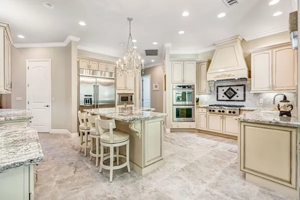 a kitchen with granite countertop a stove sink and cabinets