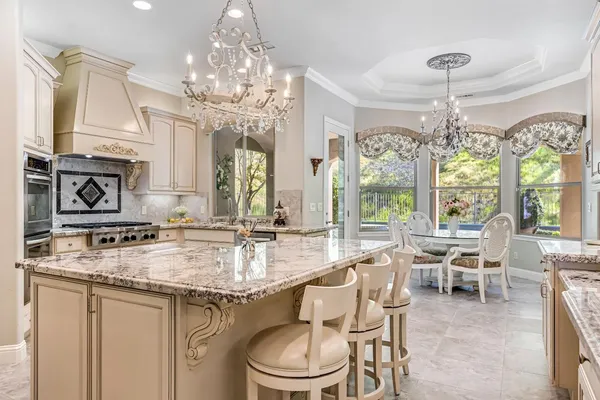 a dining room with furniture a chandelier and wooden floor