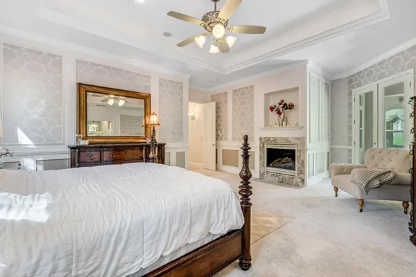 a bedroom with a bed and a chandelier