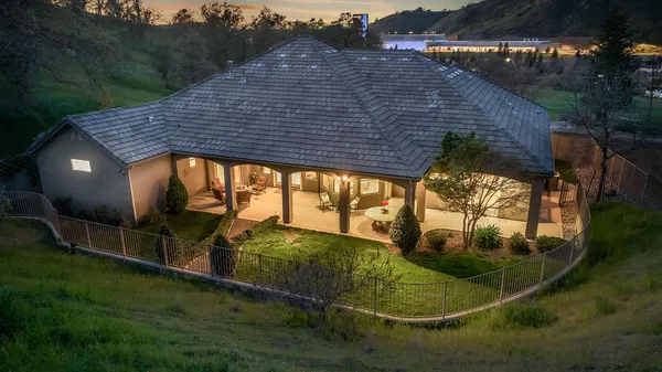 a view of a house with swimming pool and yard