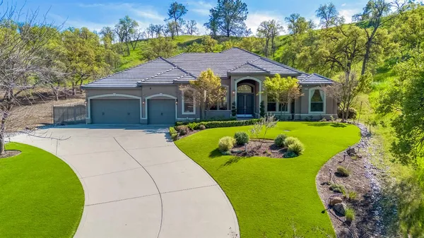 a view of a house with swimming pool and a yard