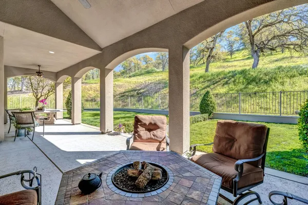 a front view of a house with a yard and outdoor seating