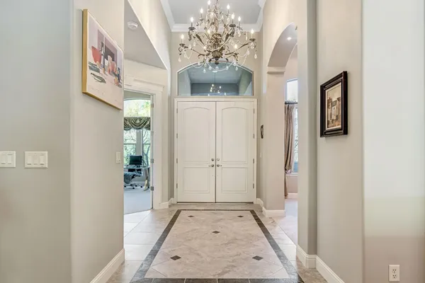 a living room with furniture and a chandelier