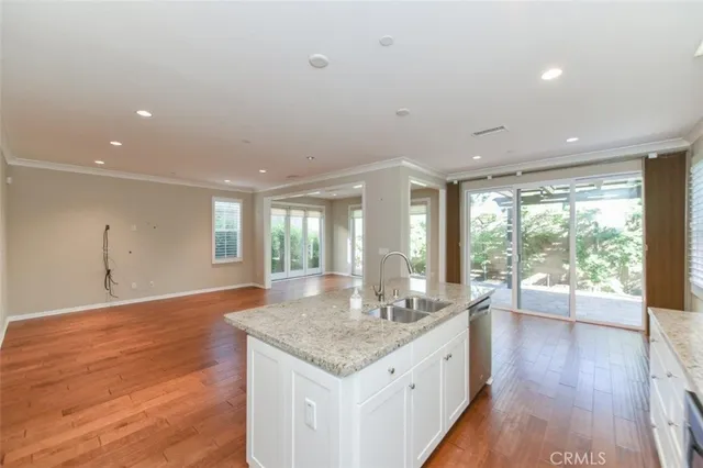 a large kitchen with granite countertop a large counter top and sink