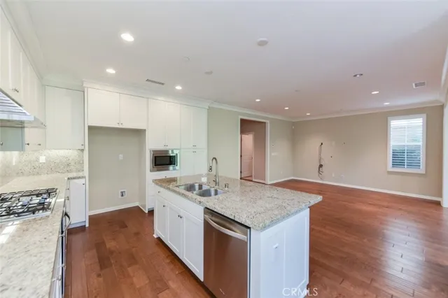 a kitchen with a stove a refrigerator a sink and a oven
