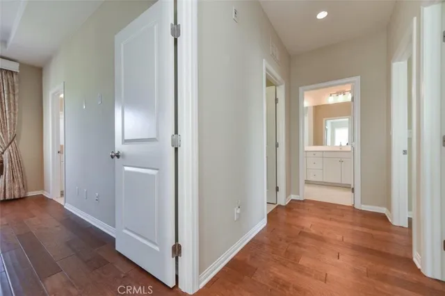 a view of a hallway with wooden floor