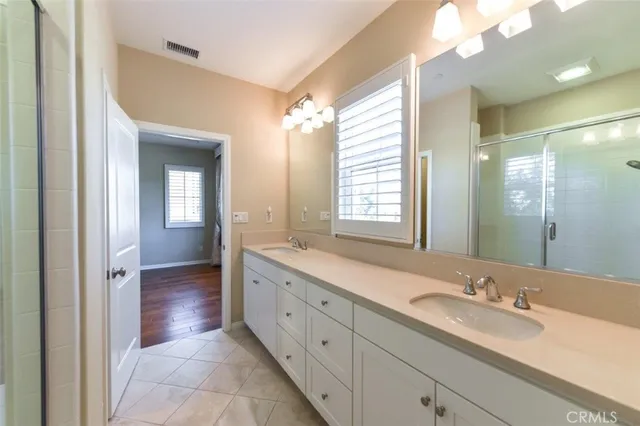 a spacious bathroom with a granite countertop sink mirror and a shower