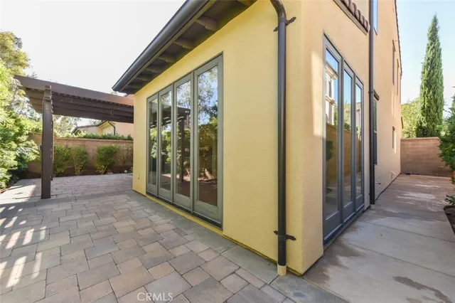 a view of a porch with a table and chairs