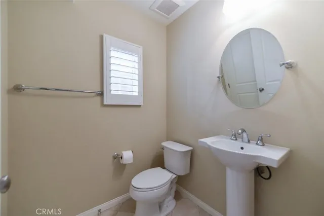 a bathroom with a sink toilet and mirror