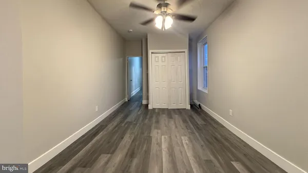 a view of an empty room and wooden floor
