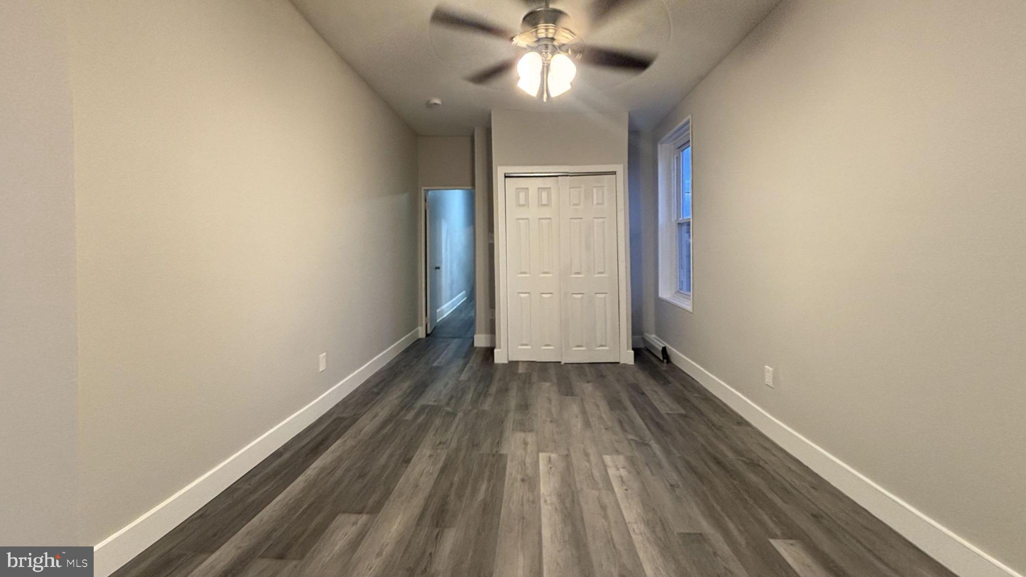 a view of an empty room and wooden floor