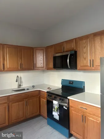 a kitchen with stainless steel appliances granite countertop a sink stove and microwave